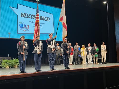 color guard on stage with boe members in background